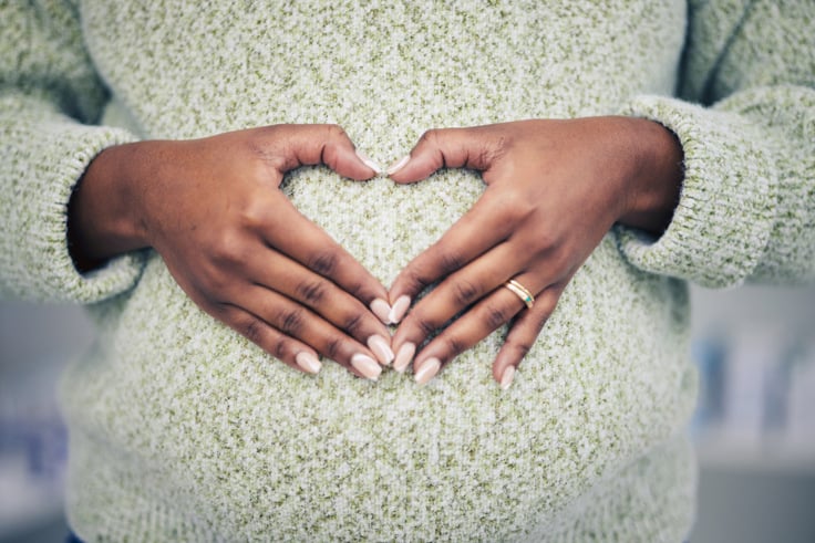 Photo of pregnant woman with heart on belly